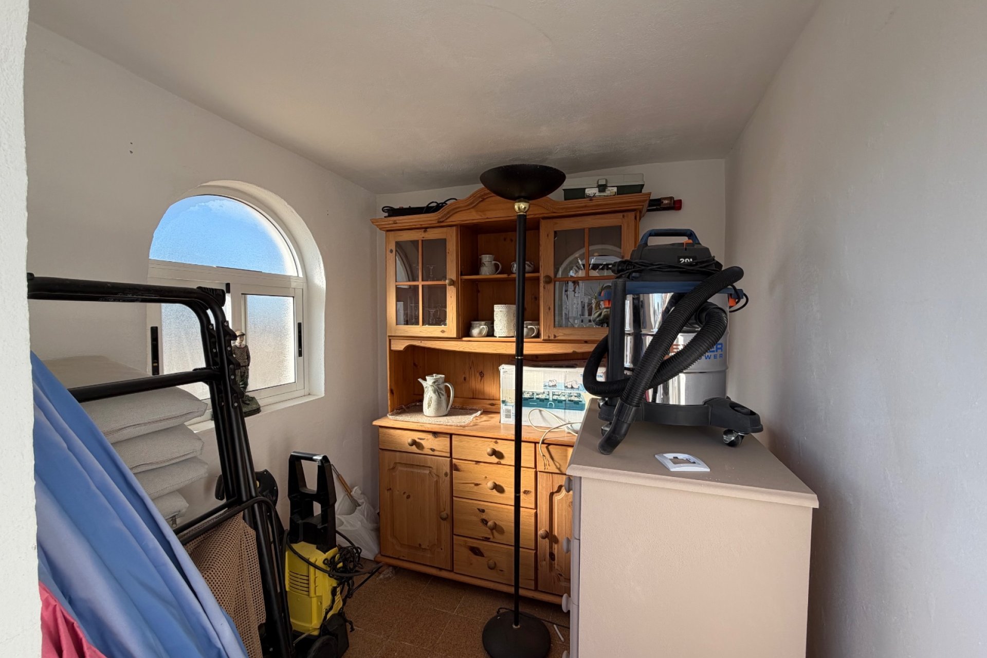 Solarium with a small bedroom or storage room with window